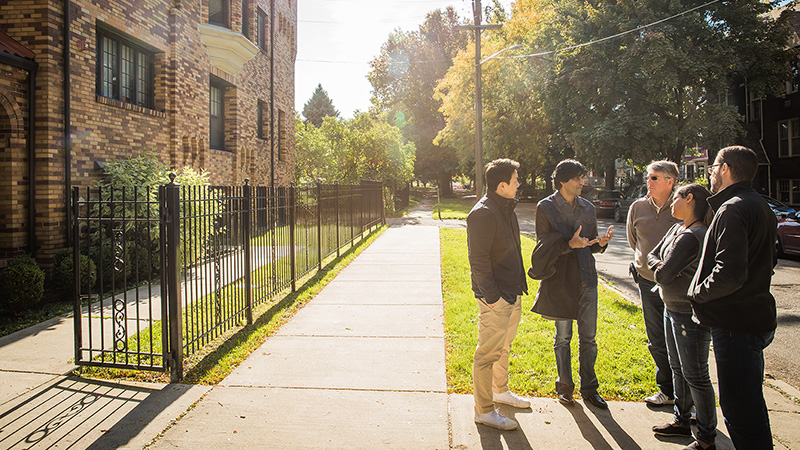 The Detroit Service Corps team speaking with Steve Palackdharry, the nonprofit’s communications director, outside of Whitdel Apartment building, SWS’ affordable housing.