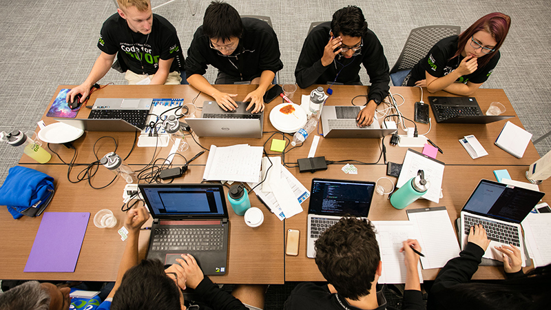 Students working around a table