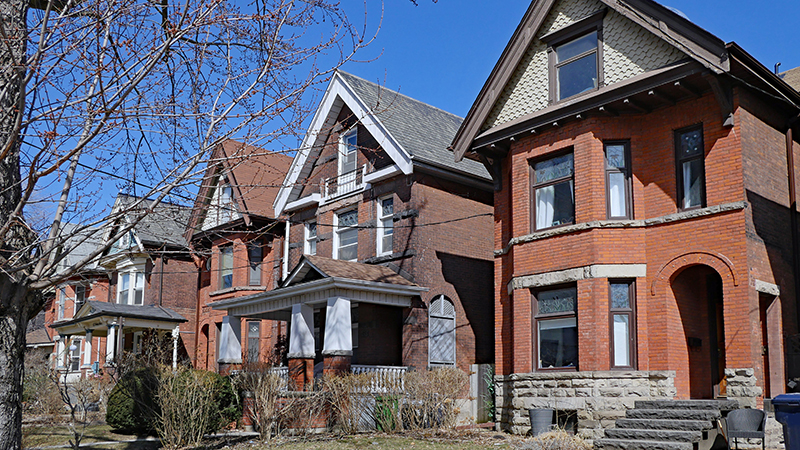 1139171596 Row of large old Victorian style detached brick houses with gables