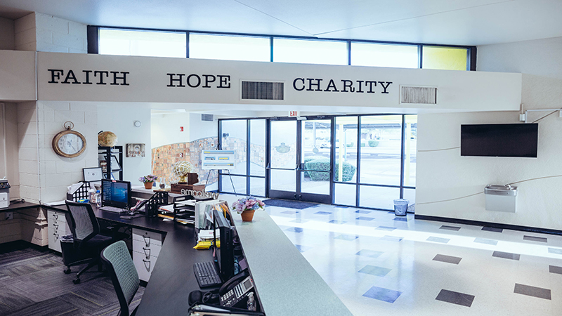 The YMCA slogan, “Faith, hope charity”, is still proudly displayed in the NLF YET College Prep lobby, reminding visitors and students of the building’s original purpose. 