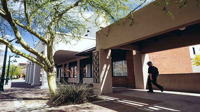 A student walks toward the recently-opened Alhambra Residence Hall. 